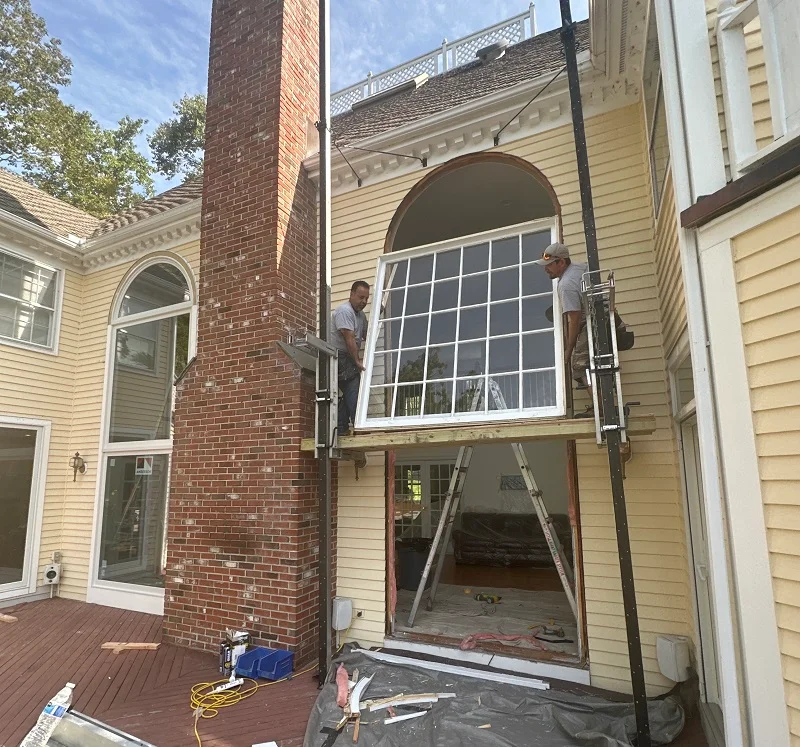 Lowering the scaffolding down with the old window